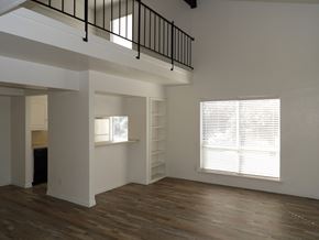 Dallas apartment for rent - A room with wooden floors and a window with blinds.