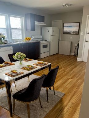 Cambridge apartment for rent - A dining room with a table set for two and a kitchen in the background.