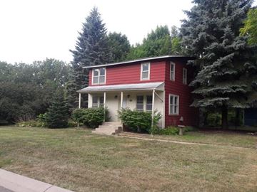 Mound house for rent - A red house with white trim and a porch.