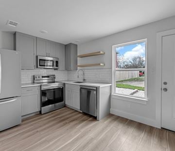 Houston apartment for rent - A kitchen with a refrigerator, oven, and microwave.
