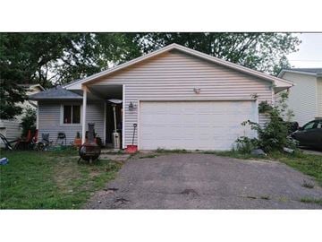 Coon Rapids house for rent - A house with a garage and a driveway.