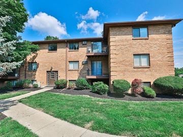 Fairfield house for rent - A brick apartment building with a green lawn in front.
