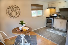 Lakewood apartment for rent - A modern kitchen with a round table and a white chair.
