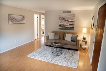 Lakewood apartment for rent - A living room with a couch, a coffee table, and a painting on the wall.