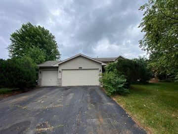 Elk River house for rent - A house with a grey roof and two garage doors.