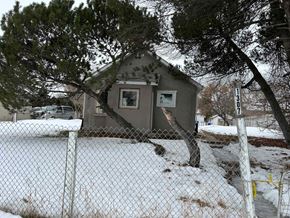 Prince Albert house for rent - A small house is surrounded by a chain link fence.