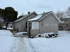 Prince Albert house for rent - A house with the number 1307-14W on it is surrounded by snow.