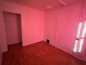 Prince Albert house for rent - A room with wooden floors and white walls with a door on the right.