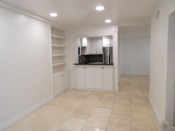 Dallas apartment for rent - A kitchen with white cabinets and a black countertop.