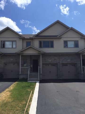 Kingston house for rent - A house with a grey roof and a white garage door.