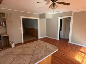 Palatka house for rent - A room with a ceiling fan and a tile floor.