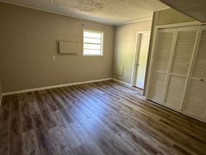 Palatka house for rent - A room with wooden flooring and a window.
