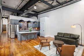 Monroe apartment for rent - A modern kitchen with a bar area and a couch.