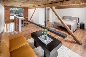 Monroe apartment for rent - A living room with a brown leather couch and a black coffee table.