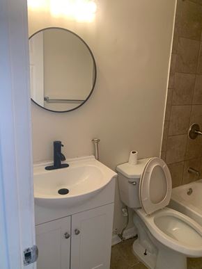 Baltimore house for rent - A white toilet with a roll of toilet paper on top of it.