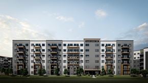 Saskatoon apartment for rent - A modern apartment building with balconies and a green lawn in front.