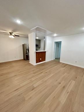 Houston apartment for rent - A room with wooden flooring and a ceiling fan.