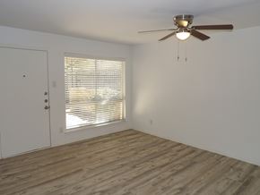 Dallas apartment for rent - A room with a ceiling fan and a window with blinds.