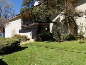 Dallas apartment for rent - A building with a balcony and a tree in front of it.