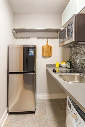 Tampa apartment for rent - A kitchen with a stainless steel refrigerator and a microwave above the stove.