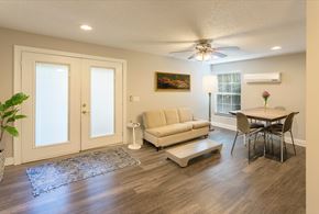 Tampa apartment for rent - A living room with a couch, chair, and a painting on the wall.