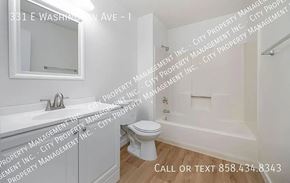 Escondido apartment for rent - A white bathroom with a toilet, sink, and bathtub.