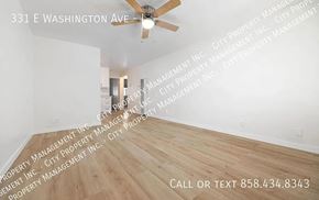 Escondido apartment for rent - A room with a ceiling fan and wooden flooring is shown with a watermark of a property management company.