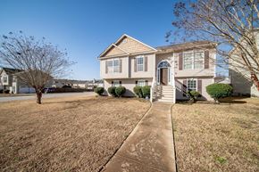 Phenix City house for rent - A house with a brown lawn and a clear blue sky.