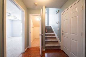 Phenix City house for rent - A hallway with a staircase leading to a bedroom.