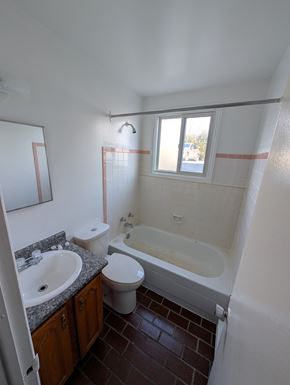 Arnprior apartment for rent - A bathroom with a toilet, sink, and bathtub.