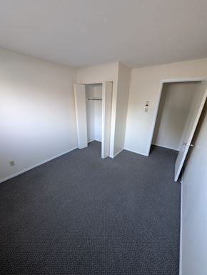 Arnprior apartment for rent - A room with carpeted floor and two open doors.