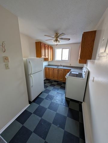 Arnprior apartment for rent - A kitchen with a checkered floor and a ceiling fan.