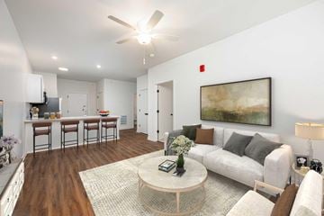 Indianapolis apartment for rent - A living room with a white couch, a coffee table, and a painting on the wall.