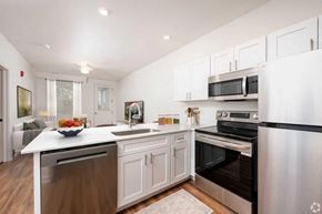 Indianapolis apartment for rent - A modern kitchen with stainless steel appliances and white cabinetry.