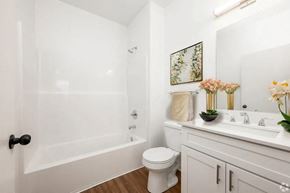 Indianapolis apartment for rent - A white bathroom with a toilet, sink, and bathtub.