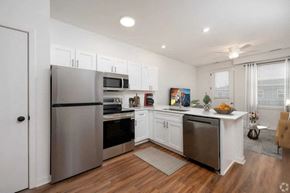 Indianapolis apartment for rent - A modern kitchen with stainless steel appliances and white cabinets.