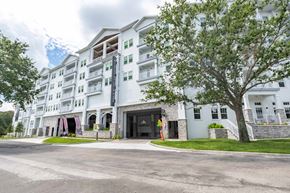 Orlando apartment for rent - A large white building with a black door and windows.