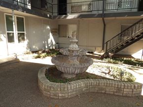 Dallas apartment for rent - A stone fountain in the middle of a courtyard.
