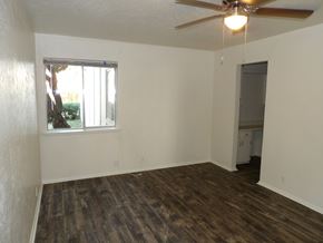 Dallas apartment for rent - A room with a ceiling fan and a window.