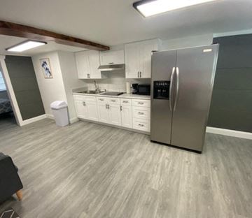 Lakeland apartment for rent - A kitchen with a refrigerator, sink, and cabinets.