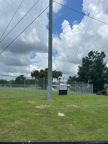 Lakeland apartment for rent - A sign in the middle of a grassy field reads "For Sale".