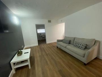 Lakeland apartment for rent - A living room with a grey couch and a white coffee table.
