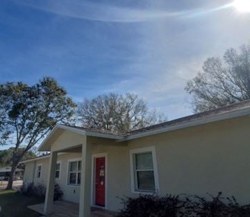 Lakeland apartment for rent - A house with a red door and white trim under a blue sky.