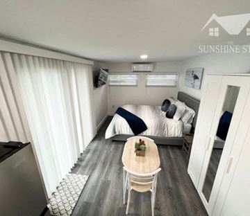 Lakeland apartment for rent - A small room with a bed, a table, and a chair.