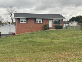 Johnson City house for rent - A red brick house with a white door and windows.