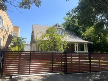 Los Angeles apartment for rent - A house with a brown fence in front of it.