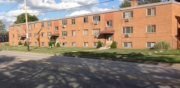 Cleveland apartment for rent - A red brick apartment building with a green lawn in front.