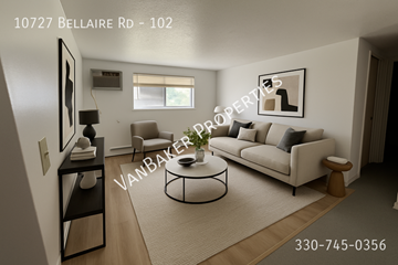 Cleveland apartment for rent - A living room with a sofa, a coffee table, and a painting on the wall.