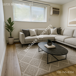 Cleveland apartment for rent - A living room with a couch, coffee table, and a plant.
