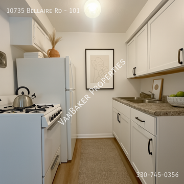Cleveland apartment for rent - A kitchen with a white stove and white cabinets.